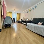 Spacious living room with sofas and wooden flooring.