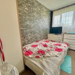 Cosy bedroom with TV and floral bedspread.