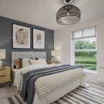Modern bedroom with blue accent wall and large window.