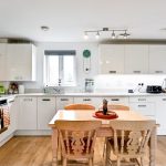 Modern kitchen with wooden dining table, bright interior