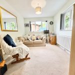 Cosy living room with sofas and window view.