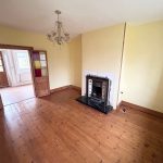 Living room with wooden floors and fireplace.