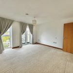 Empty room with carpet and large window.