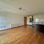 Modern flat with wood flooring and integrated kitchen.