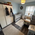Cosy baby room with crib and wardrobe.