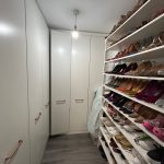Walk-in wardrobe with organised shoe collection
