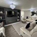 Modern living room with white sofas and decor.