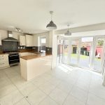 Modern kitchen with garden view and natural light.