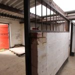 Empty stable with open red door