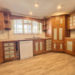 Rustic wood kitchen with ample storage and dishwasher.