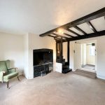 Cosy room with fireplace and green armchair