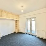 Unfurnished room with carpet and French doors.