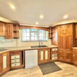 Wooden kitchen with modern fixtures and natural light.