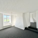 Bright white room with carpet and window view.