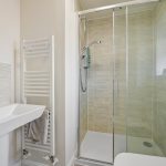 Modern bathroom with glass shower enclosure.