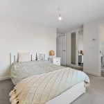 Modern bedroom with ensuite bathroom and wardrobe