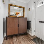 Home entrance with cabinet and mirror.
