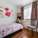 Cosy bedroom with floral decor and chair