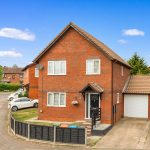 Red brick house with driveway and garage