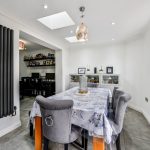 Modern dining room with table and grey chairs.