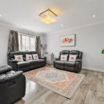 Modern living room with leather sofas and vibrant rug