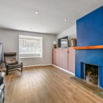 Modern living room with blue fireplace.
