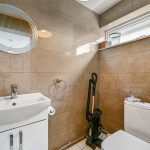 Compact modern bathroom with sink and toilet