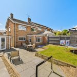Brick house with garden and trampoline.