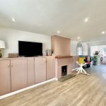 Spacious living room with TV and fireplace.