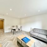 Bright living room with dining table and sofa.