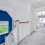 Modern home hallway with blue accent wall.