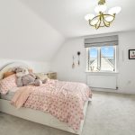 Cosy bedroom with pink bedding and soft toy
