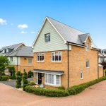 Modern suburban house with brick exterior and garden.