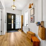 Bright hallway with wooden floor and decorative elements.