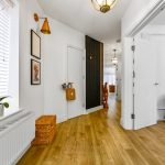 Bright hallway with wooden flooring and decor.