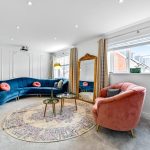 Modern living room with colourful furniture and decor.