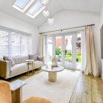 Bright living room with garden view and modern decor.