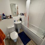 Small bathroom with bath, sink, and toilet