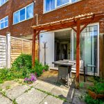 Sunny garden with patio and pergola