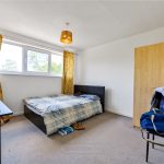 Bright bedroom with double bed and wardrobe.