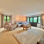 Spacious living room with sofas and large windows.