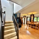 Modern dining room with staircase and wooden floor