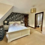 Cosy bedroom with en-suite and sloped ceiling.