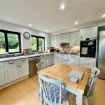 Modern kitchen with wooden dining table.