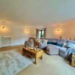 Cosy living room with sofas and wooden furniture.