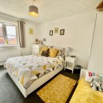 Cosy bedroom with geometric bedding and decor.