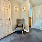 Cosy grey chair in modern hallway corner