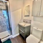 Modern bathroom with shower, sink, and toilet