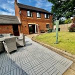 Brick house with patio furniture in garden
