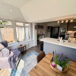 Modern kitchen and living room with natural light.